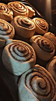 rolls are lined up on a baking sheet in the oven and ready to be baked