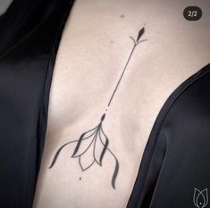 a woman with a tattoo on her chest has a flower in the shape of a leaf