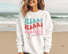 A Merry Beachmas sweatshirt makes a great beach Christmas sweater. Perfect if you're looking for a Florida or Hawaii  Christmas shirt or for any other coastal Christmas locations. The collar is ribbed knit, so it retains its shape even after washing. There are no itchy side seams on these crewneck sweatshirts. 🏝 50% cotton, 50% polyester 🏝 Runs true to size - unisex sizing 🏝 If you want oversized, go up a size or two 🏝 Models wearing the white sweatshirt is wearing a size L. The sand color sweatshirt is a medium. 🏝 Gilden 18000 sweatshirt To see more Christmas Shirts, click here: https://www.etsy.com/shop/BeachChicAndMore?section_id=30540091 Holiday Crew Neck Tops For Beach Season, Crew Neck Tops For Beach Season Holiday, White Letter Print Sweatshirt For Holidays, White Tops For Beach Season Holiday, Hawaii Christmas, Color Sweatshirt, Tropical Christmas, Beach Christmas, Coastal Christmas