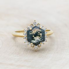 a ring with an image of a horse in the center surrounded by small white and yellow diamonds