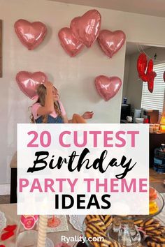 a birthday party with pink balloons and hearts on the wall