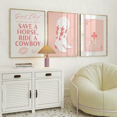 two pink posters hang on the wall above a white cabinet and sideboard in a living room