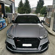 an audi car is parked at a gas station