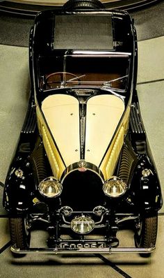 an old fashioned car parked in a garage