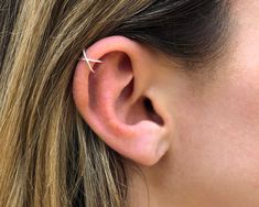 a close up of a person's ear with a small white star on it