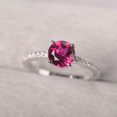 ◆ The classic prong setting ring features the pink ruby. The sliver band is adorned with zircons, making it a dainty half eternity ring. ◆ Production Description: Main stone Type: Lab Ruby Main Stone Shape: Round Cut Main Stone Size: 7*7 Side stone: CZ Metal: 925 Sterling silver - Other options available in the drop down menu ◆ Customization: √Add Engraving √Other Metal Type Available √Other Gemstones & Shapes Available √Personalization Requests Available ◆ Packaging: To give you a complete Classic Solitaire Ring, July Birthstone Ring, Green Sapphire Ring, Minimalist Engagement Ring, Pink Ruby, Ruby Diamond Rings, London Blue Topaz Ring, Half Eternity Ring, Rose Engagement Ring