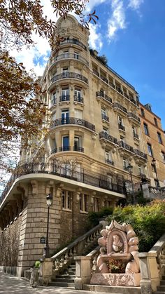 an old building with many balconies on the top and stairs leading up to it