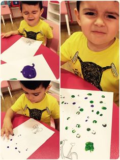 a young boy sitting at a table working on his art project