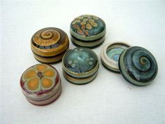 six ceramic knobs with designs on them