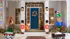 christmas decorations on the front porch of a house with lights and snowman figures outside