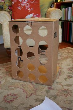 an open cardboard box sitting on top of a rug