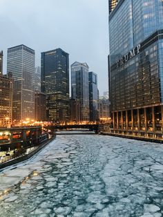 an icy river in the middle of a city