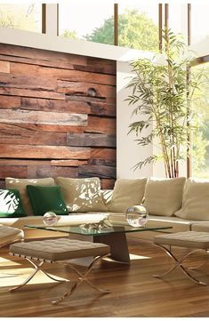 a living room filled with furniture and a wooden paneled wall behind the couches