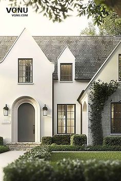 the front view of a white house with two story windows