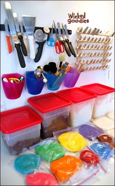 there are many plastic containers and utensils on the counter