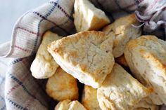 a basket filled with scones sitting on top of a table