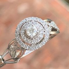 a diamond ring is shown on top of a brick wall