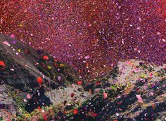 colorful confetti is falling from the sky over a mountain side and into the air