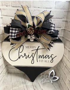 a merry christmas sign hanging on the side of a brick wall