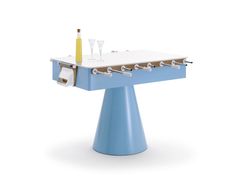 a blue and white table with glasses on it's top, next to a wine glass holder