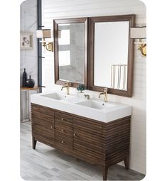 a bathroom vanity with two sinks and mirrors