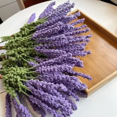 lavender flowers are laid out on a tray