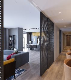 a living room filled with furniture next to a dining room table and two couches