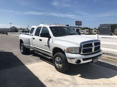 a white pickup truck parked in a parking lot