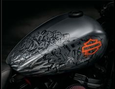 a close up of a motorcycle with graffiti on it