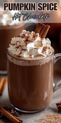 pumpkin spice hot chocolate in a mug with whipped cream and cinnamon