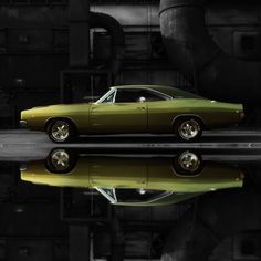 a green muscle car parked in front of a black and white background with water reflecting on the floor