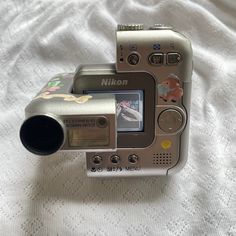 a digital camera sitting on top of a bed