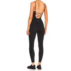 Lezat Jumpsuit Lorna Criss-Cross Organic Cotton Jumpsuit - Black Functional Second-skin Activewear For Gym, Second-skin Functional Activewear For Gym, Functional Nylon Stretch Bodysuit, Functional Stretch Nylon Bodysuit, Black Sports Jumpsuit, Seamless Second-skin Activewear For Yoga, Compression Elastane Unitard For Gym, Functional Second-skin Yoga Activewear, Stretch Bodysuit With Mesh Back For Gym