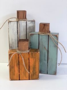 three wooden blocks tied together with twine