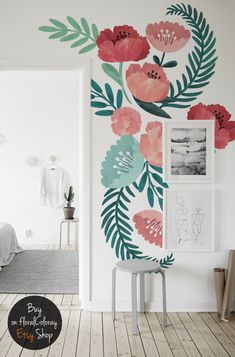 a white room with flowers painted on the wall