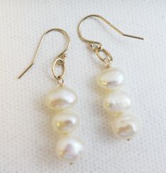 ✦✦ 7-9mm (plus/minus) white cultured freshwater  pearls are wirewrapped on to gold filled earwires. ✦✦ All findings are goldfilled. Length is approximately 4 cm ✦✦ Please note that these may vary slightly from the photo as freshwater cultured pearls unique. ✦✦ These are great for every day . These will be shipped from Norway I have  real passion for beautiful embellishments, wearable design and gorgeous handmade jewellery. I am inspired by exotic cultures, exquisite stones and the essential colours of nature.  I showcase a unique fusion of colored gemstone jewellery,  modern yet timeless design and masterful craft techniques to create unique gemstone jewellery for everyday modern women. White Wire Wrapped Pearl Earrings For Gift, White Wire Wrapped Round Pearl Earrings, White Hypoallergenic Pearl Earrings In 14k Gold, Hypoallergenic White Pearl Earrings In 14k Gold, Nickel-free Pearl White Pearl Earrings, Nickel-free White Pearl Earrings In 14k Gold, Silver Pearl Earrings With 14k Gold Filled Ear Wire, Anniversary Wire Wrapped Pearl Earrings, Craft Techniques