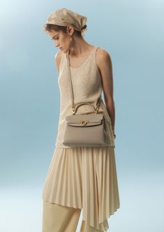 Inspired by Grace Kelly's enduring style, the Grace Soft Top Handle Bag is meticulously crafted from premium USA full-grain textured calfskin leather, ensuring both durability and elegance. Its timeless and versatile design features a thoughtfully structured interior that comfortably accommodates all your everyday essentials. Whether day or night, you'll find yourself instinctively reaching for this chic and easy-to-wear masterpiece. Timeless Textured Leather Bag For Everyday Luxury, Elegant Beige Pebbled Leather Shoulder Bag, Elegant Pebbled Leather Shoulder Bag, Elegant Pebbled Leather Shoulder Bag For Work, Elegant Pebbled Leather Satchel For Work, Elegant Shoulder Bag In Pebbled Leather, Elegant Pebbled Leather Shoulder Bag With Soft Leather, Elegant Soft Leather Bags For Everyday Luxury, Elegant Soft Pebbled Leather Shoulder Bag