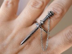 Unique and  artfully crafted Skull Sword ring is made of high grade Stainless Steel and has oxidation for depth and details.Sword is attached by a chain to the ring.-Length of the sword is 1 3/4" -We ship in a gift box. Pretty Knives, Fest Outfits, Mode Hippie, Edgy Jewelry, Biker Jewelry, Magical Jewelry, Punk Jewelry, Funky Jewelry, Fantasy Jewelry