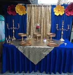 a table topped with lots of gold and blue decorations