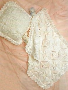 an old fashioned white lace bralet on a pink sheet