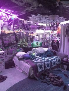 a bed room with a neatly made bed and purple lighting