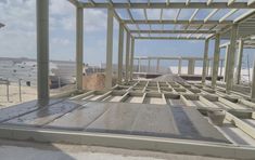 the inside of a building under construction with lots of steel beams and concrete flooring