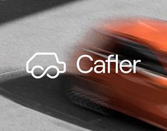 an orange car with the word cafer on it's side in front of a blurry background