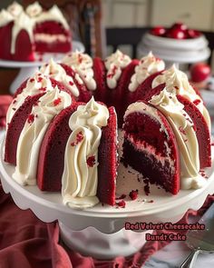 a red velvet cheesecake with white frosting on a cake platter, ready to be eaten