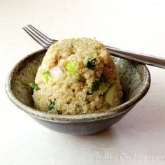 a bowl filled with food next to a fork