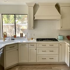 a kitchen with an oven, sink and dishwasher