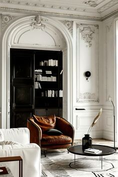 a living room filled with furniture and a book shelf