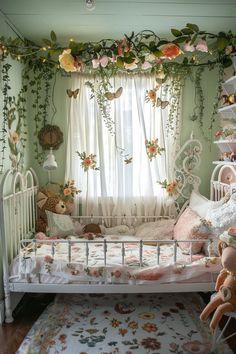 a baby's crib with stuffed animals and flowers hanging from the ceiling, in front of a window