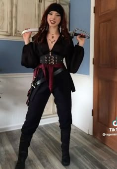 a woman dressed in pirate costume posing for the camera