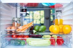 an open refrigerator filled with fruits and vegetables